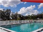 View larger image of A large swimming pool with lounge chairs at BREEZY OAKS RV PARK image #11