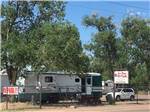  A view of the front sign with an RV at OM PLACE RV PARK - thumbnail