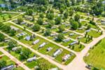 Aerial view of grassy sites at Northwoods RV Resort - thumbnail