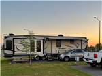 A fifth wheel trailer backed in at LAKE CHARLES RV RESORT BY RJOURNEY - thumbnail