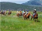 A group of people horseback riding nearby - thumbnail