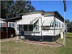Sunny mobile home with flag outsideat The Oaks at Zephyrhills - thumbnail