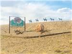 Five horse statues by a sign - thumbnail