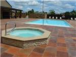 View larger image of The large swimming pool and hot tub at HIDDEN CREEK RV RESORT image #11