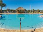 View larger image of Pool with covered gazebo in background at SUNKISSED VILLAGE RV RESORT image #1
