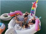 A group of women sitting in a floating unicorn at KO-KET RESORT - thumbnail