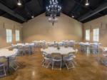 Interior of the rec hall with tables and chairs at TEXAS RANCH RV RESORT - thumbnail