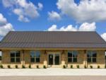 Exterior of the gold brick rec hall at TEXAS RANCH RV RESORT - thumbnail