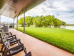 Rocking chairs overlooking the pond at TEXAS RANCH RV RESORT - thumbnail