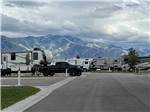 A paved road thru the RV sites with mountains in the background at ASPEN GROVE RV PARK - thumbnail