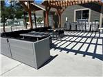 Outdoor pergola with bbq pits and tables at ASPEN GROVE RV PARK - thumbnail