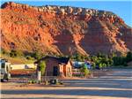 Restroom building next to sites and beautiful view of the mountain at GRAND PLATEAU RV RESORT AT KANAB - thumbnail