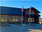 View larger image of Main office building with flags hanging at GRAND PLATEAU RV RESORT AT KANAB image #2