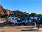 Two motorhomes parked in back in sites at GRAND PLATEAU RV RESORT AT KANAB - thumbnail