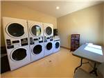 View larger image of Laundry room with washing machines and dryers at GRAND PLATEAU RV RESORT AT KANAB image #11
