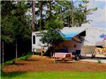View larger image of A fifth wheel trailer in an RV site at PENSACOLA NORTH RV RESORT image #8