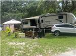 A fifth wheel trailer and car in a RV space at LOST LAKE RV PARK - thumbnail