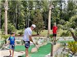 View larger image of People playing miniature golf at ISLAND OAKS RV RESORT image #10