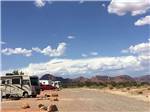 A line of gravel RV sites with mountains in the background at KAIBAB PAIUTE TRIBAL RV PARK - thumbnail