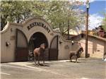 The front entrance of a restaurant with horse statues nearby at J & J RV PARK - thumbnail