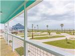 View larger image of Open concrete RV spaces with ocean in background at BLUE WATER RV RESORT image #2