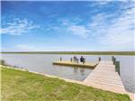 View larger image of Men fishing on dock over slow moving water at BLUE WATER RV RESORT image #8