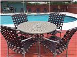 Table and chairs at the pool at Cotulla Camp Resort - thumbnail