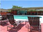 Lounge chairs at the pool at Cotulla Camp Resort - thumbnail