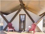 Two red chairs in front of a glamping tent at VERDE RANCH RV RESORT - thumbnail