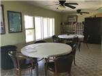 A room with round tables and chairs at Amigo Inn & RV Park - thumbnail