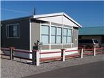 Manufactured home surrounded by wooden fence at GOLDWATER MOBILE HOME & RV PARK - thumbnail