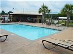 View larger image of Swimming pool and deck with chaise lounges at TEXARKANA RV PARK image #3