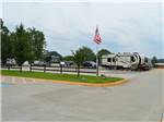View larger image of Large RVs and trailers parked near park entrance flag at TEXARKANA RV PARK image #4