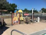 A view of the playground from the pool at TEXARKANA RV PARK - thumbnail