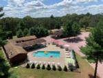 Aerial shot of wooded area and pool at Dells Camping Resort - thumbnail