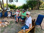 RVers gathered around a fire at ST JOHNS RV RESORT - thumbnail