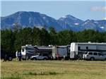 A row of motorhomes in grassy sites at CHEWING BLACK BONES CAMPGROUND - thumbnail