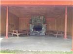 Canopy covers wooden picnic chairs and fireplace at CHEWING BLACK BONES CAMPGROUND - thumbnail