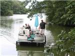 Three men and a boy on a pontoon boat at OAK TERRACE RV RESORT - thumbnail