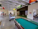 View larger image of Kids playing ping pong in the rec room at OAK TERRACE RV RESORT image #12