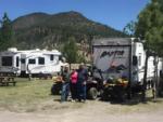 People standing in front of their ATVs and RV - thumbnail