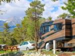 A brown and black motorhome parked in a RV site at BLACK BEAR RETREAT - thumbnail