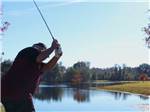 A man getting ready to hit a golf ball at MADISON RV & GOLF RESORT - thumbnail