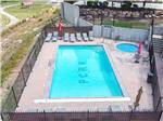 Pool and hot tub with lounge chairs at PARK CITY RV RESORT - thumbnail