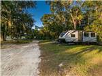 View larger image of A sandy road next to an RV site at STEINHATCHEE RIVER CLUB image #11