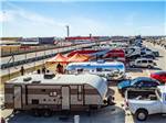 Travel trailers lined up next to the racing track at COTA CAMPING-PREMIUM RV PARK - thumbnail