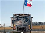 The back of an RV with a flag flying at COTA CAMPING-PREMIUM RV PARK - thumbnail
