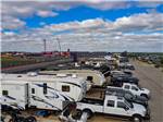 A row of trailers parked next to the race track at COTA CAMPING-PREMIUM RV PARK - thumbnail