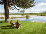 A couple enjoying the view by the water at THE RETREAT, LINKS & SPA AT SILVIES VALLEY RANCH - thumbnail