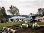Two motorhomes parked next to a pavilion at MOTORCOACH RESORT LAKE ERIE SHORES - thumbnail
